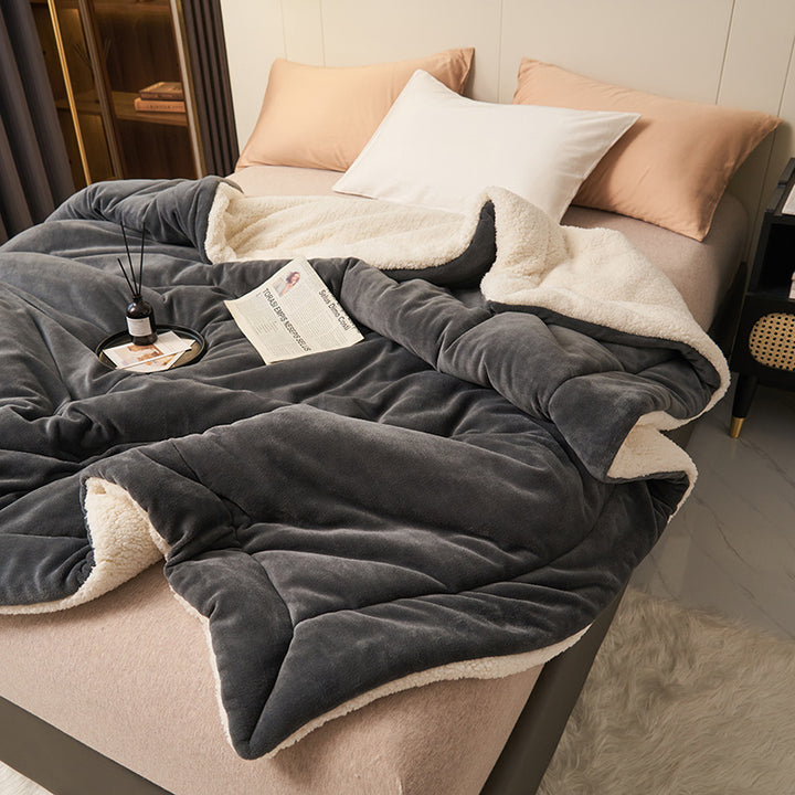 Reversible sherpa throw on a bed