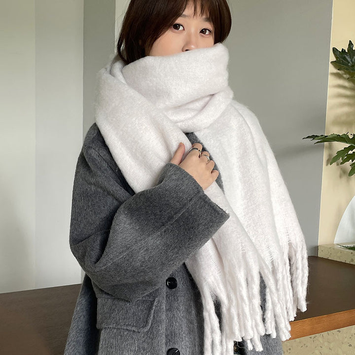 Woman wrapped in a fluffy oversized scarf