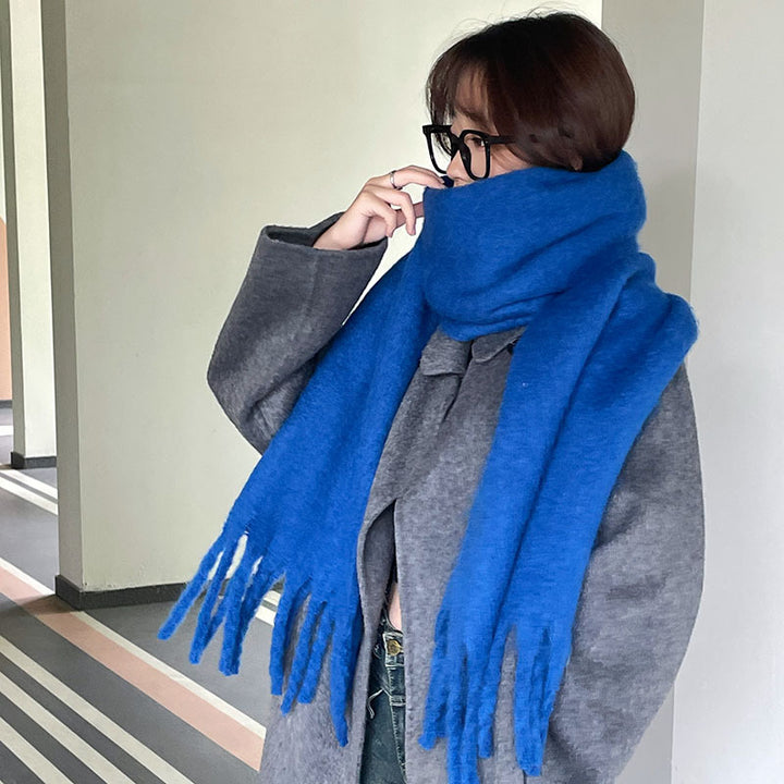 Woman wrapped in a fluffy oversized scarf