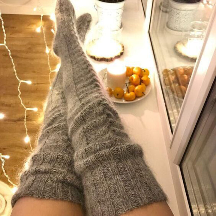 Woman wearing over-the-knee cable knit socks