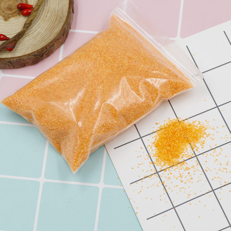 Colorful magic sand in water