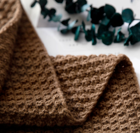 Waffle knit throw with pom-pom fringe