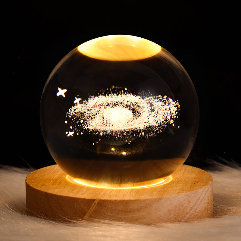 Glowing crystal ball with Saturn engraving