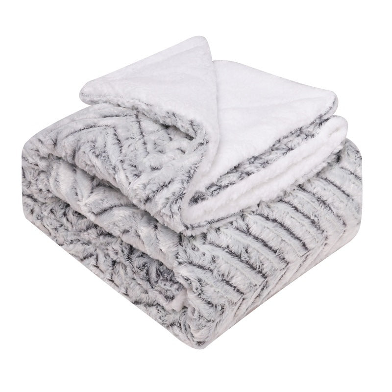 Thick sherpa fleece throw on a sofa