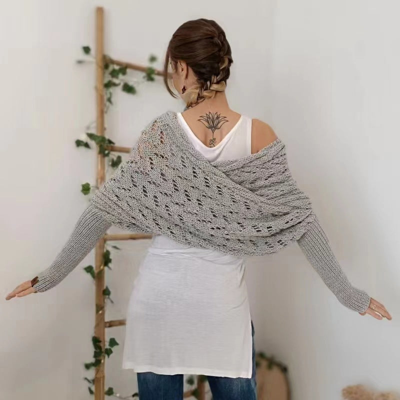 Woman wearing a knit shawl with sleeves