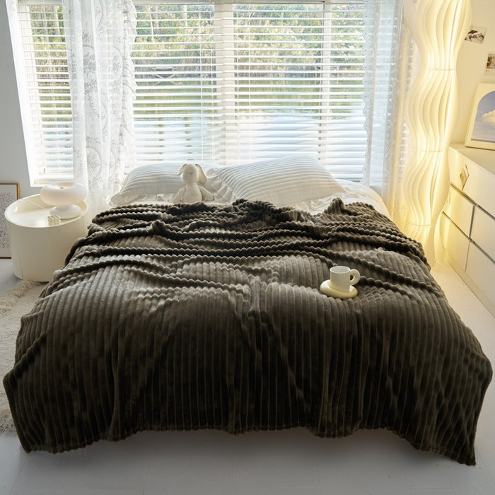 Ribbed faux rabbit fur blanket on bed