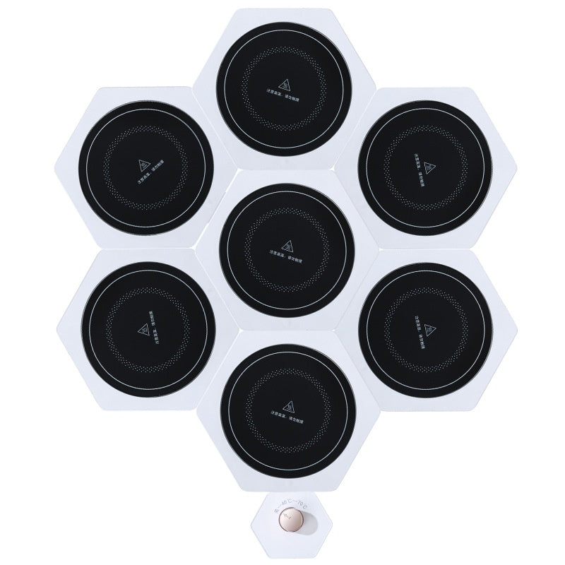 White hexagonal food warming plates joined in a cluster