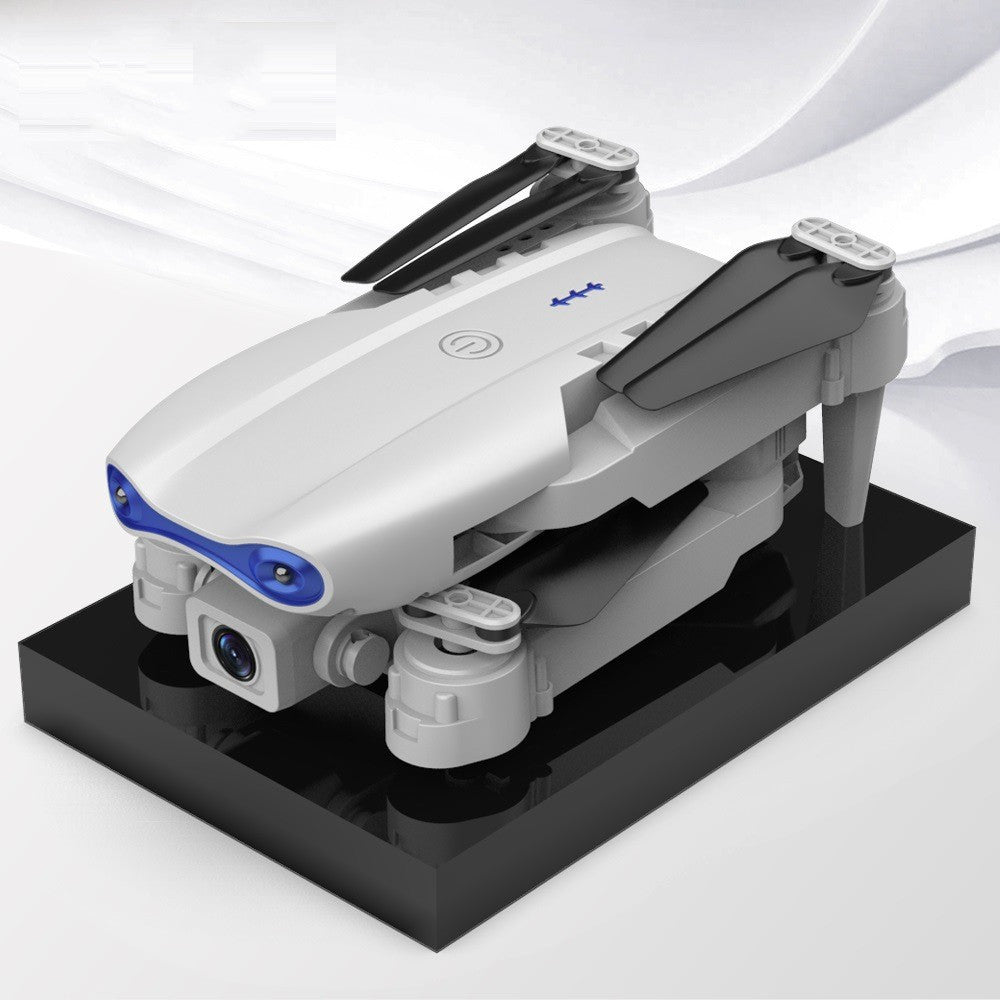 Black foldable camera drone in flight