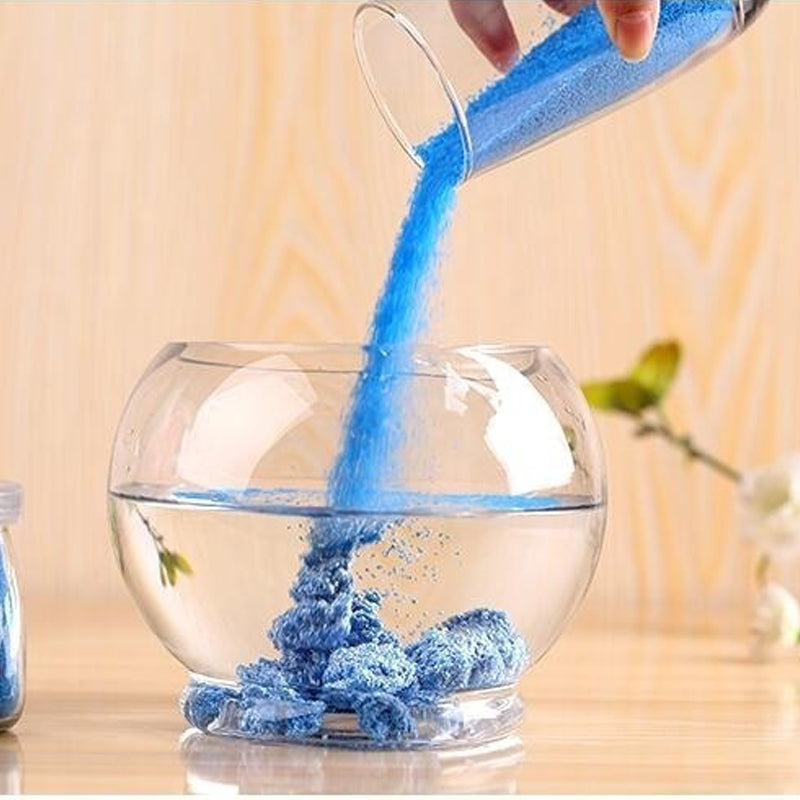Colorful magic sand in water