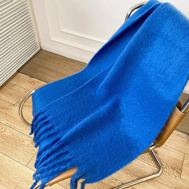 Woman wearing a fluffy royal blue scarf