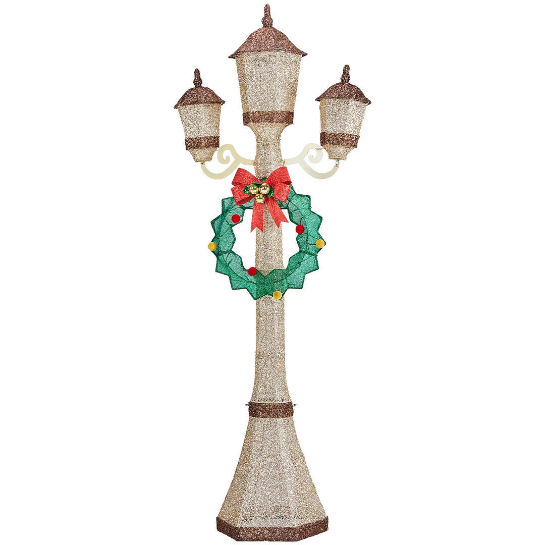 Gold Christmas lamp post with wreath glowing