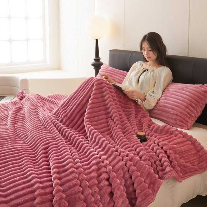 Ribbed faux rabbit fur blanket on bed