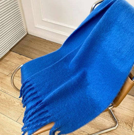 Woman wearing a fluffy royal blue scarf