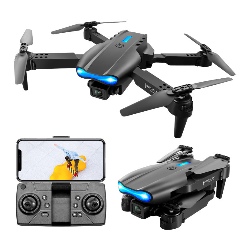 Black foldable camera drone in flight