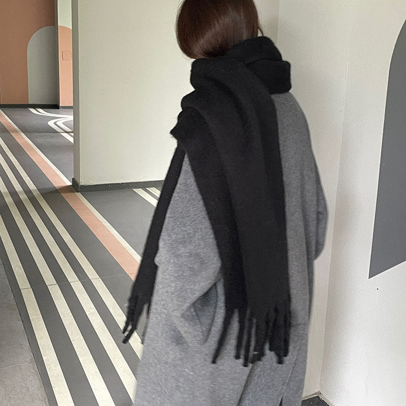 Woman wrapped in a fluffy oversized scarf