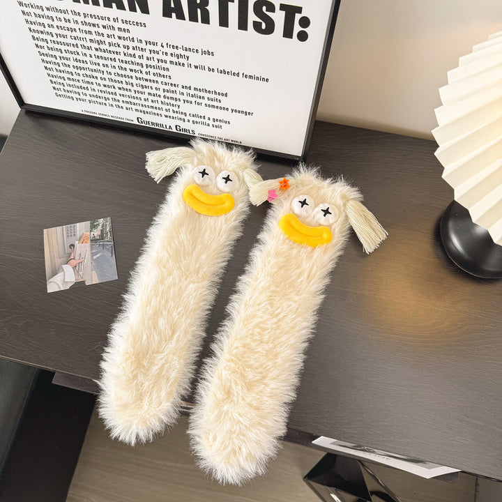 Fluffy green plush socks with googly-eyed monster faces