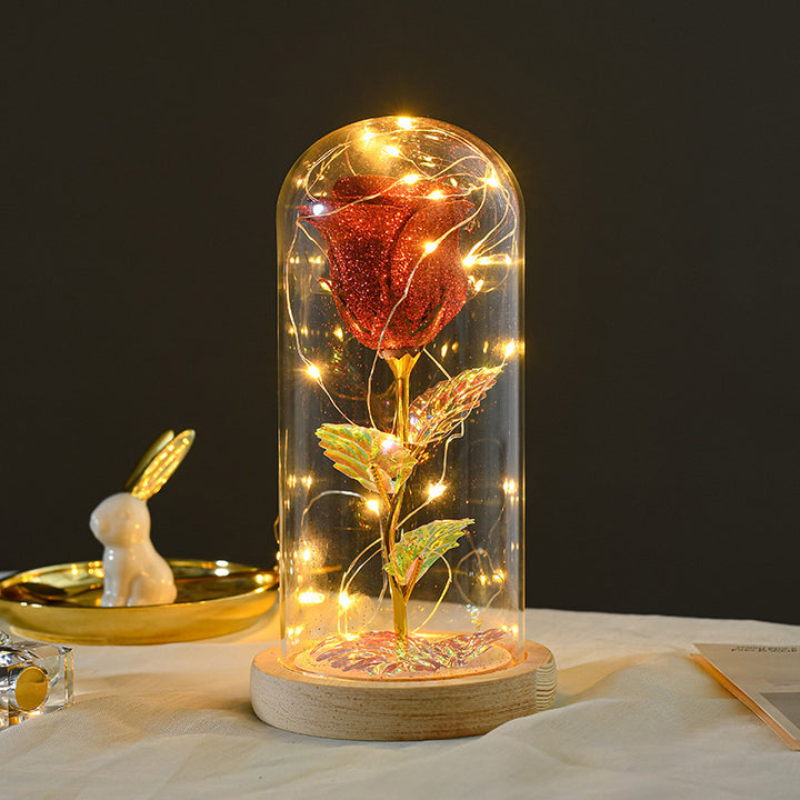 Preserved rose under glass dome with lights
