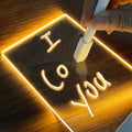 Glowing acrylic message board lamp on wooden base