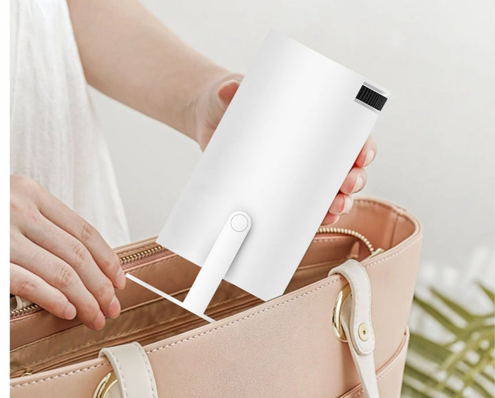 White portable mini projector on tilting stand