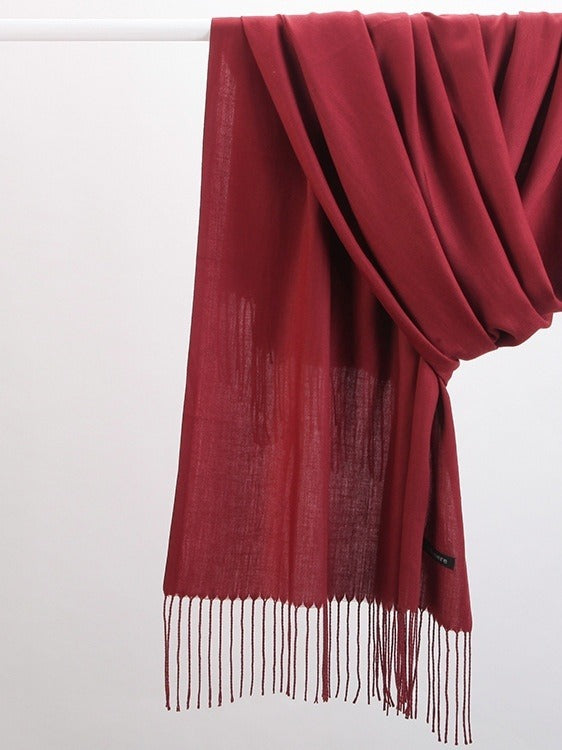 Woman wearing a soft wine red scarf