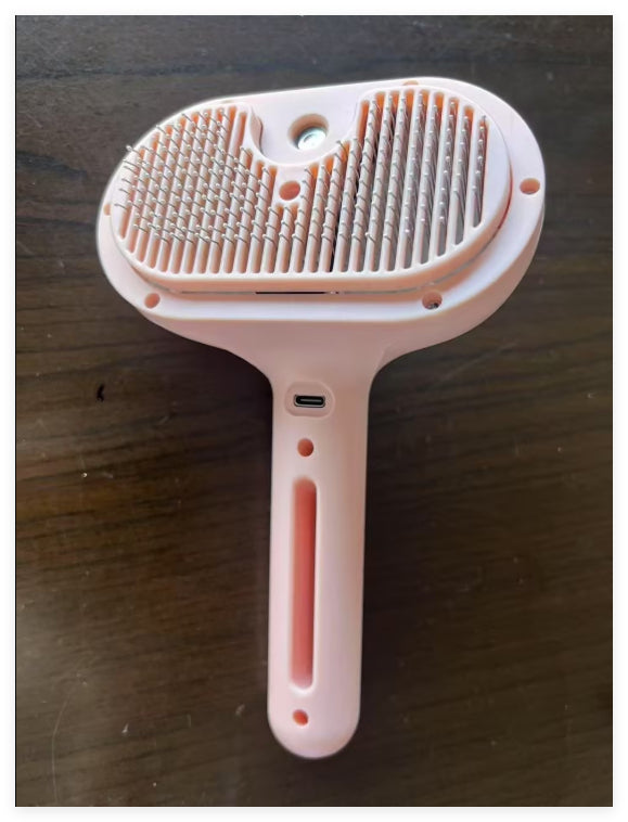 Self-cleaning pet brush with mist spray