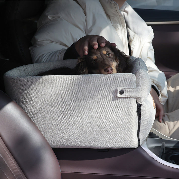 Small dog in armrest car seat bed