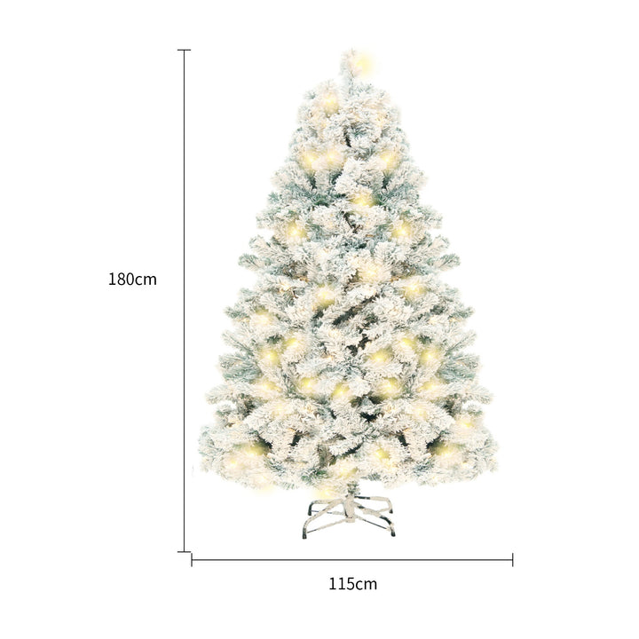 Snow-flocked white Christmas tree with warm-white lights