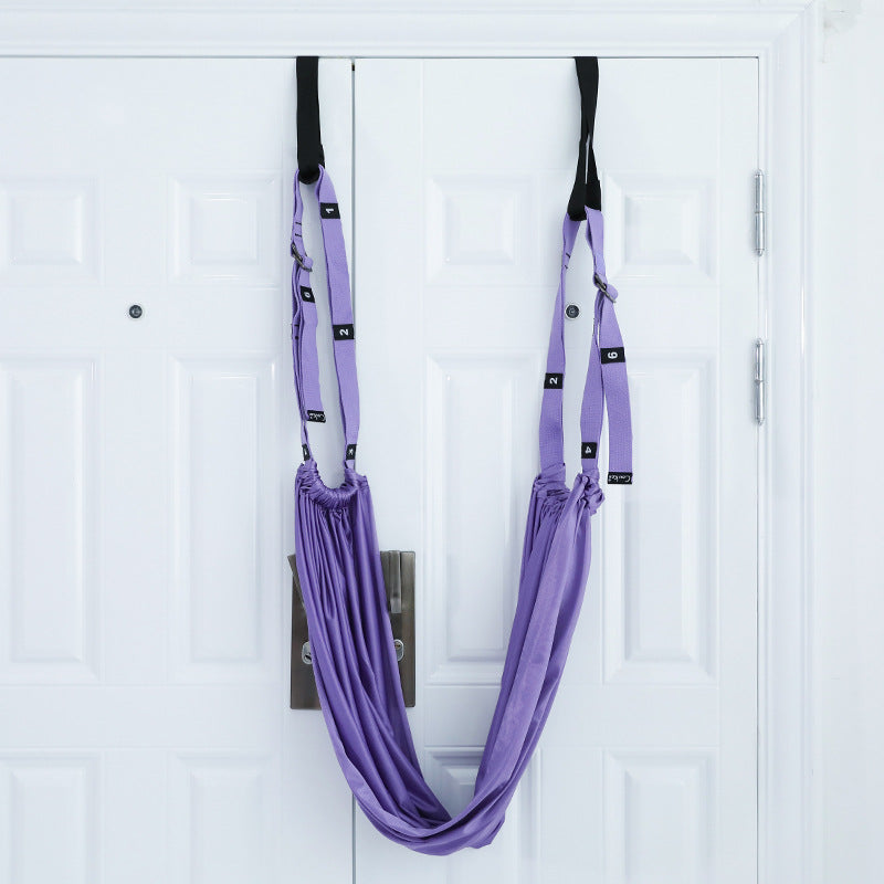Woman stretching with a door yoga strap