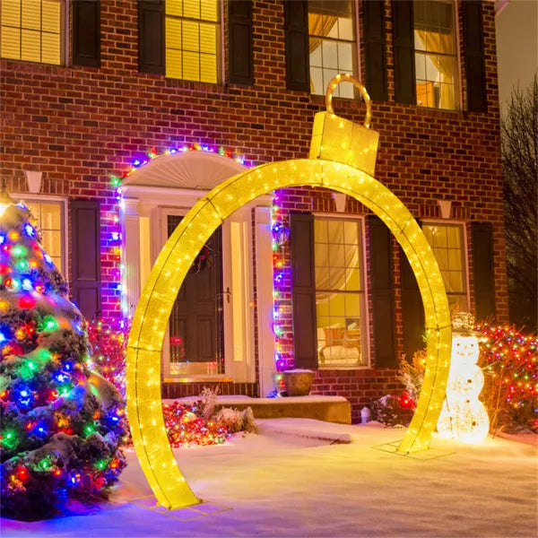 Lighted Christmas ornament archway at night