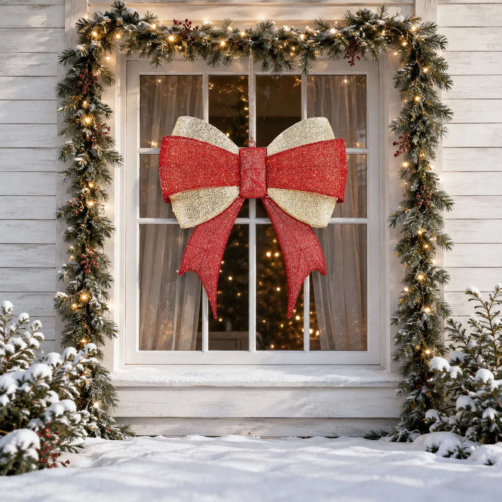 Large lighted red and gold Christmas bow