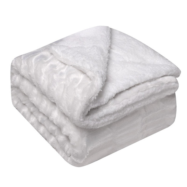 Thick sherpa fleece throw on a sofa