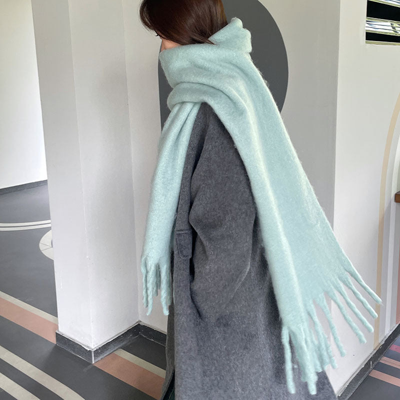 Woman wrapped in a fluffy oversized scarf