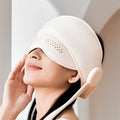 Person wearing a hooded head and eye massager