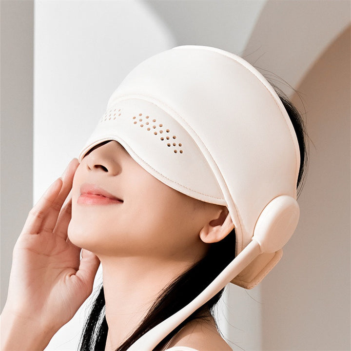 Person wearing a hooded head and eye massager