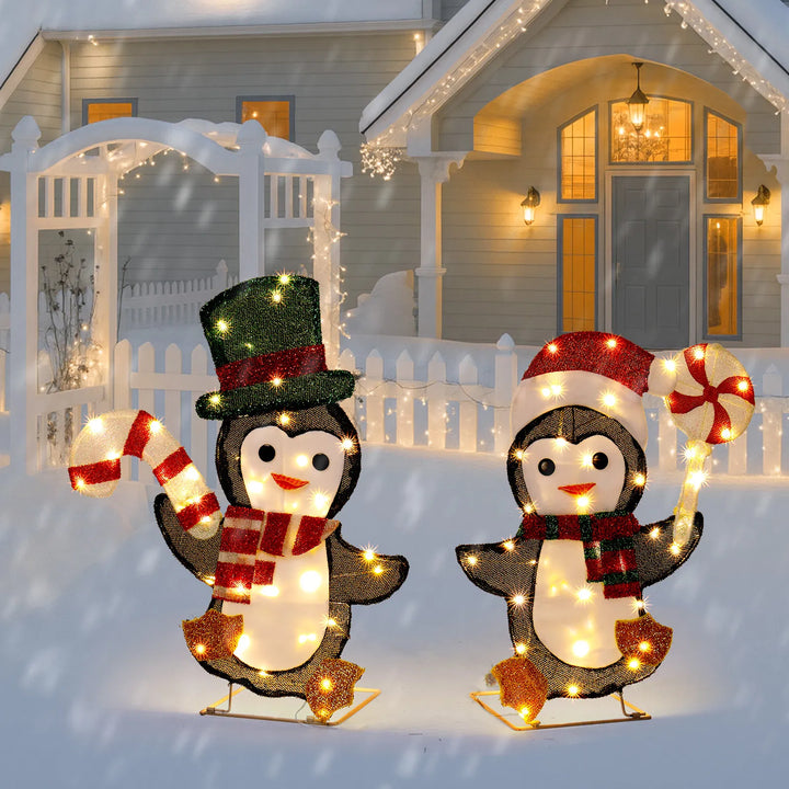 Two lighted penguins with candy canes