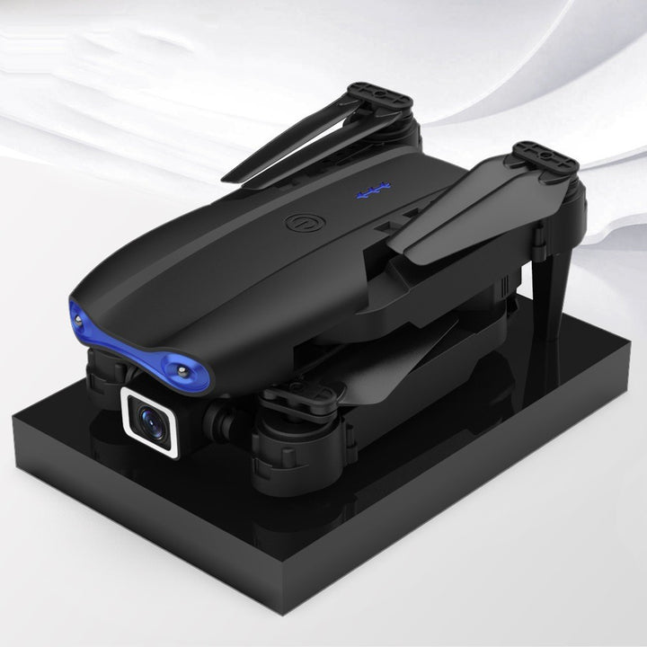 Black foldable camera drone in flight