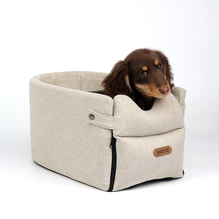 Small dog in armrest car seat bed