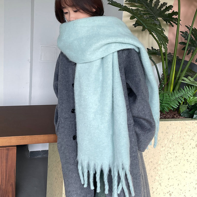 Woman wrapped in a fluffy oversized scarf