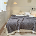 Cable-knit jacquard blanket with sherpa border
