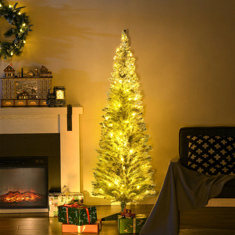Pre-lit snow flocked pencil tree glowing warm