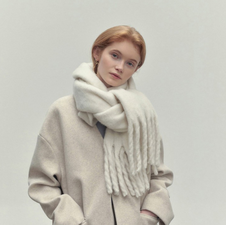 Woman wearing a long camel scarf