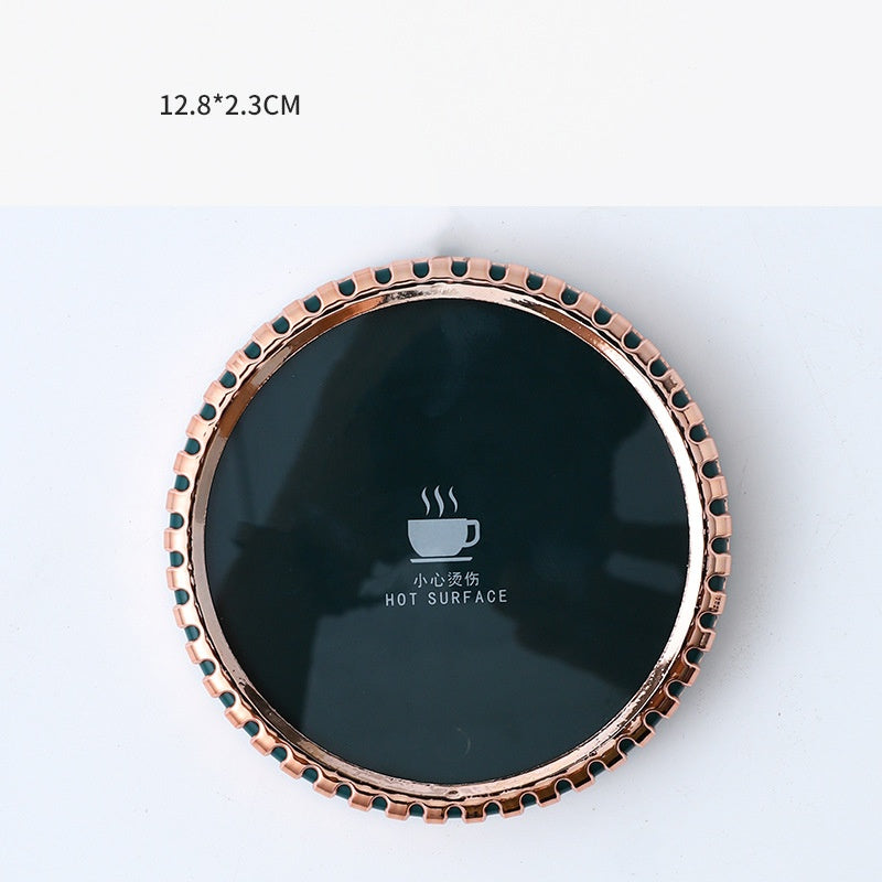 Mug on a round heated coaster with metallic rim