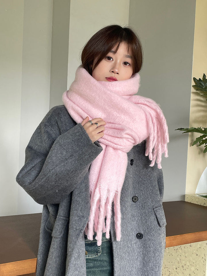 Woman wrapped in a fluffy oversized scarf