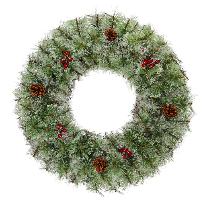 Two lit Christmas wreaths on a front door
