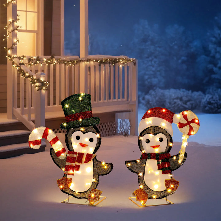 Two lighted penguins with candy canes
